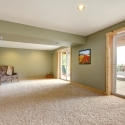 Ground level large new living room with green walls.