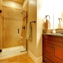 Bathroom with wood cabinet and tile shower.